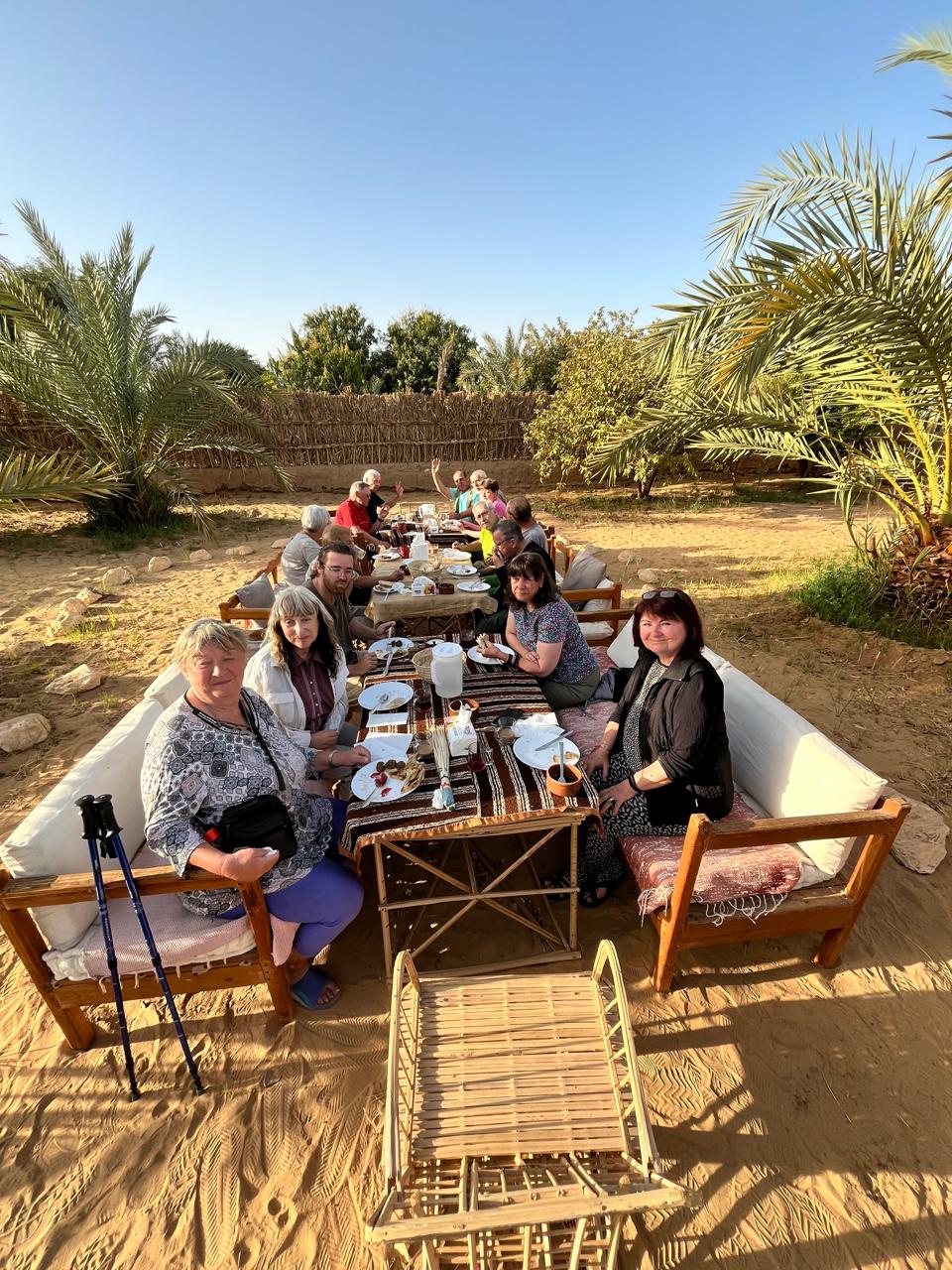 Guests dining under the palms